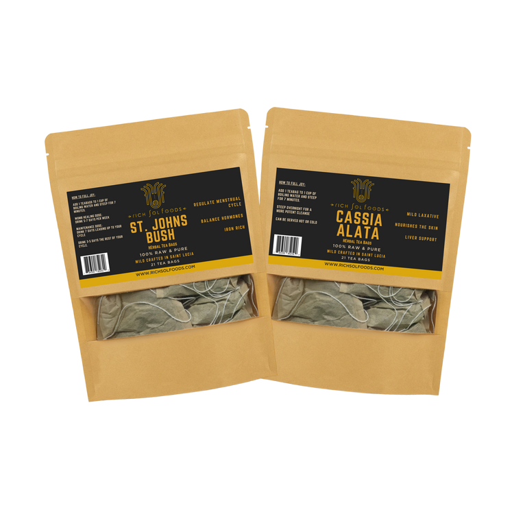 Two open cardboard packages with tea bags inside, featuring labels for 'St. John's Bush' and 'Cassia Alata'.